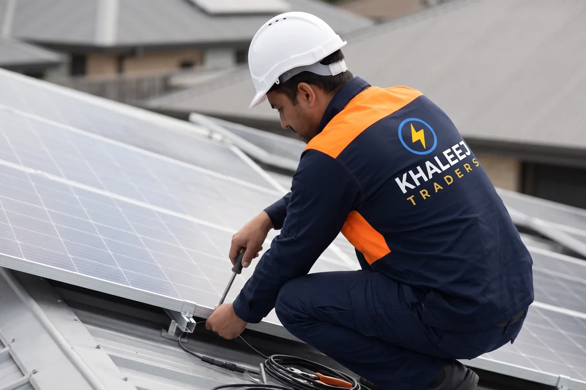 Khaleej Traders technician wiring rooftop solar panels in Lahore